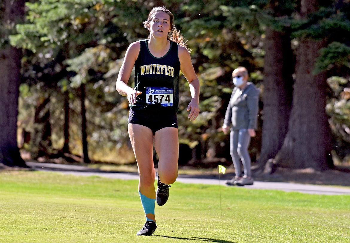Bulldog Alie Simpson on her way to the finish line at the Stumptown Triangular at Whitefish Lake Golf Club on Tuesday, Sept. 29. She was Whitefish's second fastest runner of the day for the girls. (Whitney England/Whitefish Pilot)