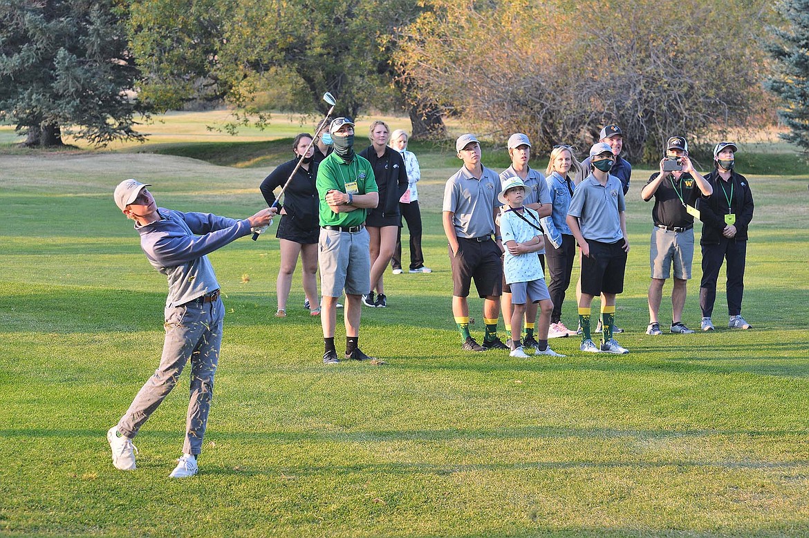 Billy Smith hits his approach shot in the sudden-death playoff Friday against fellow Bulldog Cameron Kahle  in Butte at the Class A state golf tournament. (Jeff Doorn photo)