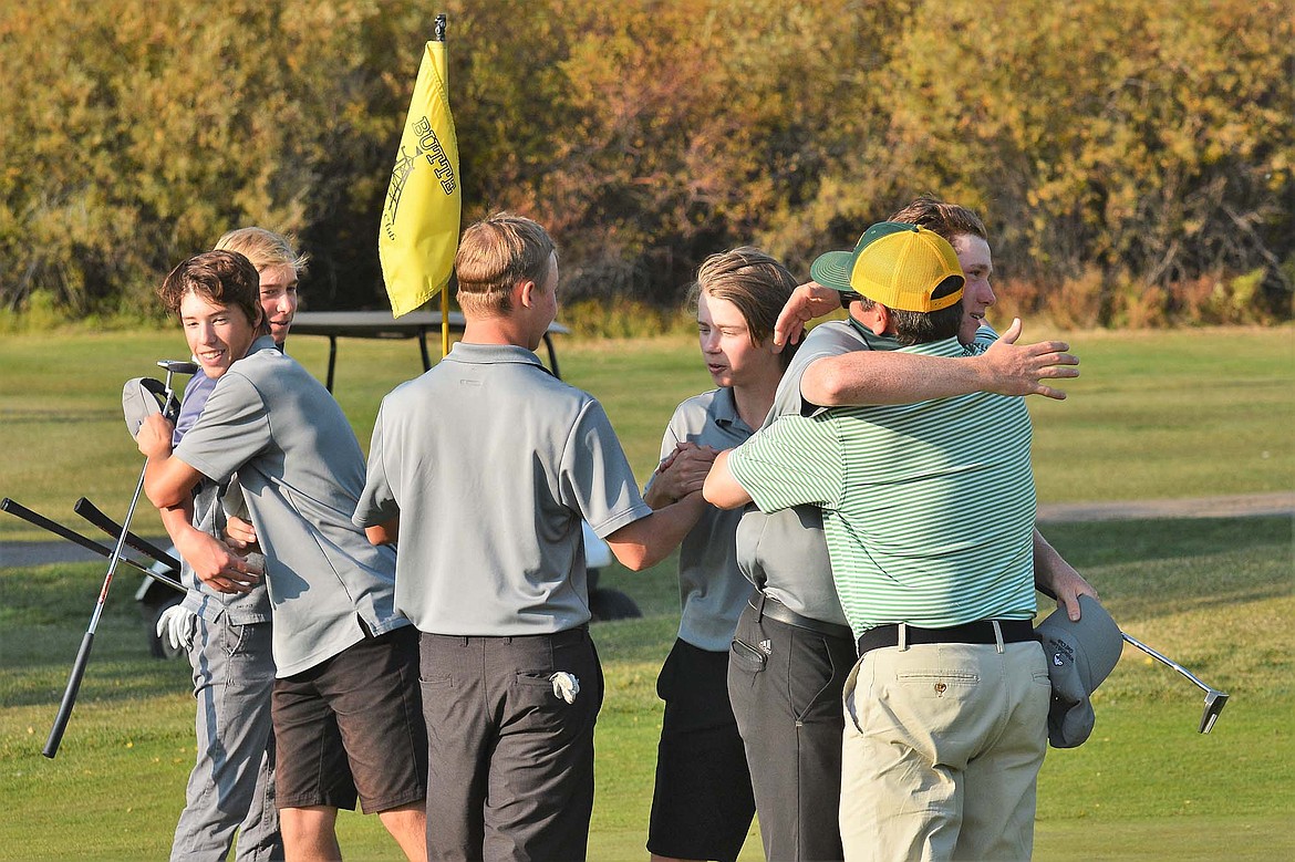 Whitefish head coach Bill Kahle and the boys golf team celebrate their State Class A Championship Friday in Butte at the state tournament. (Jeff Doorn photo)