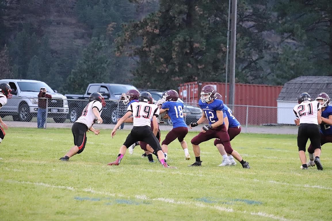 The Clark Fork Mountain Cats football team hammered Darby, 52-12, to improve to 4-2. Danger Haskins (18) and Hunter Haskins (12) block during a play in the win. (Kami Milender/Mineral Independent)