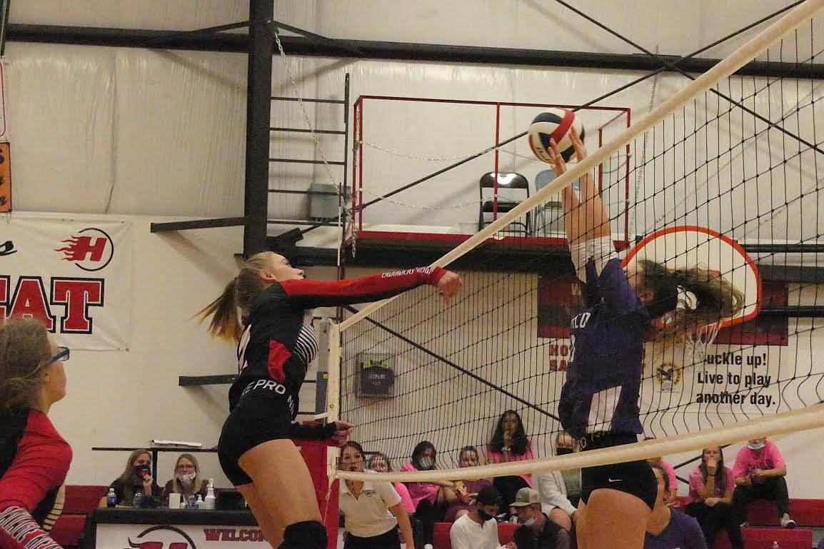 Hot Springs volleyball player Savannah Roosma slips a spike past a Charlo defender during last week’s match. (Chuck Bandel/Valley Press)