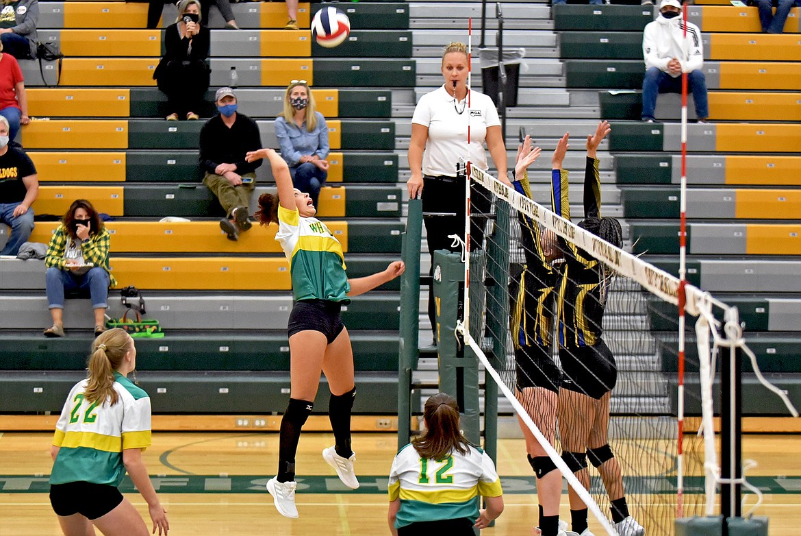 Whitefish's Emma Trieweiler goes up against Libby's blockers in the Lady Bulldogs Homecoming match Thursday evening. (Whitney England/Whitefish Pilot)