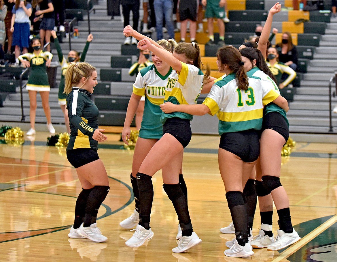 Whitefish Volleyball celebrates its straight-set win against Libby during the Bulldogs Homecoming match Thursday, Oct. 1. (Whitney England/Whitefish Pilot)