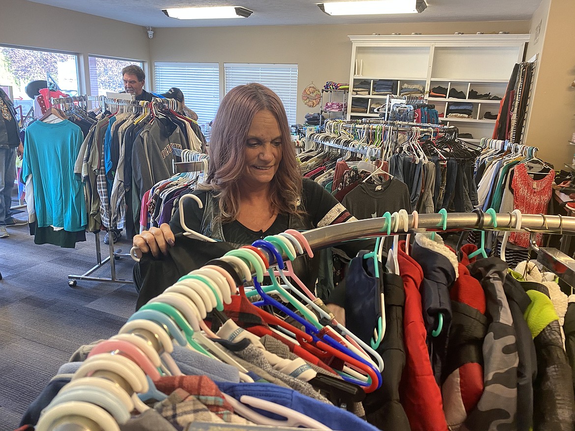 Debby Carlson, one of the founders of the Diseases and Disabilities Advocates Riding Club hangs up some of the free clothing offered at the DDARC Closest Store on Hayden Avenue. (MADISON HARDY/Press)