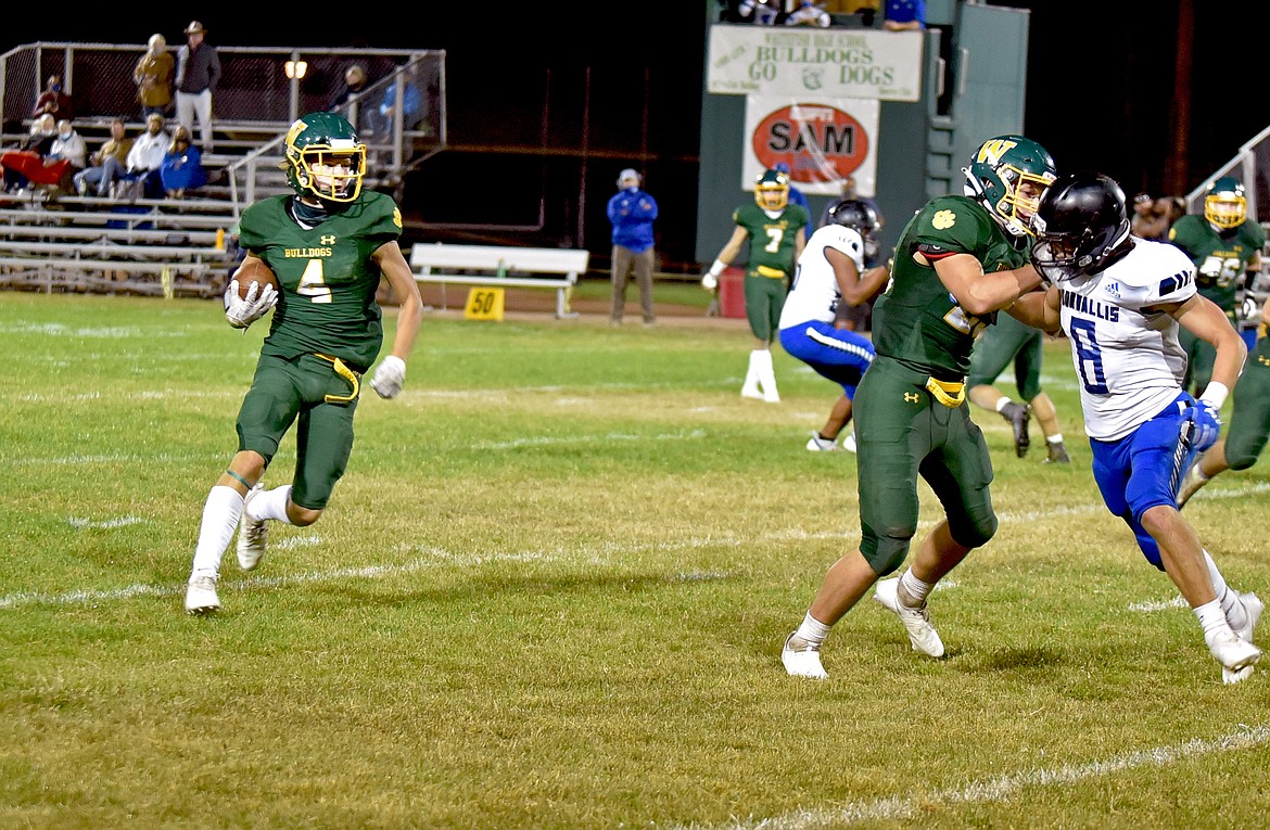 Bulldog Jaxsen Schlauch get some space to make a run upfield against Corvallis Friday night at the Dawg Pound. (Whitney England/Whitefish Pilot)