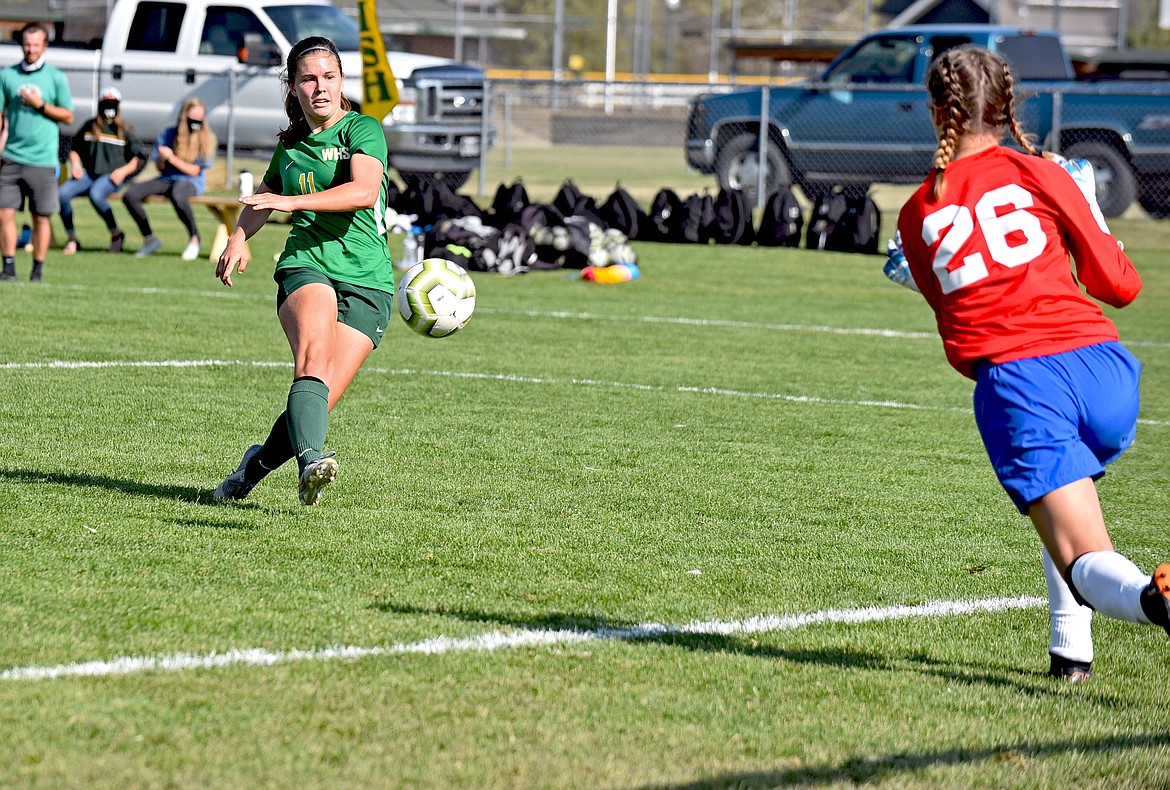 Whitefish midfielder Emma Barron drives a shot against Columbia Falls goalkeeper Nevaeh Carlin in the second half of the rivalry match at Smith Fields Saturday. (Whitney England/Whitefish Pilot)