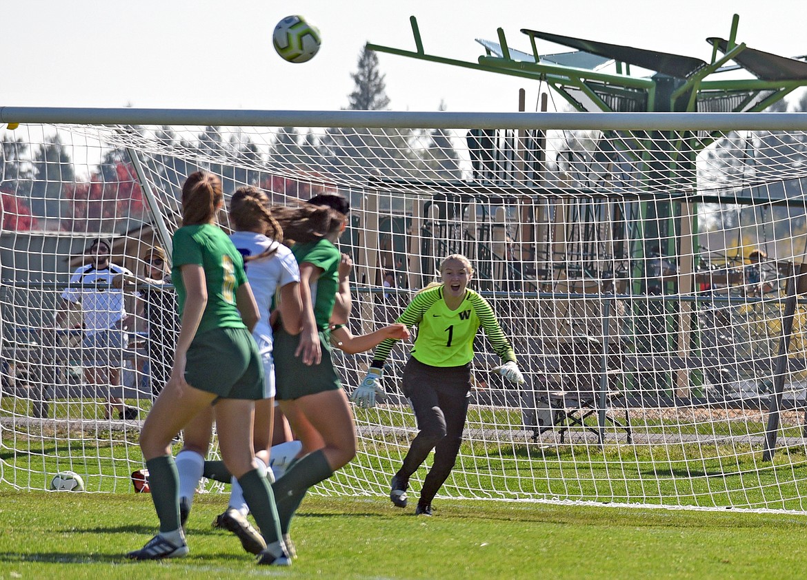 Whitefish senior goalkeeper Sami Galbraith calls for the ball as it sails over a group players in a game against Columbia Falls on Saturday. (Whitney England/Whitefish Pilot)