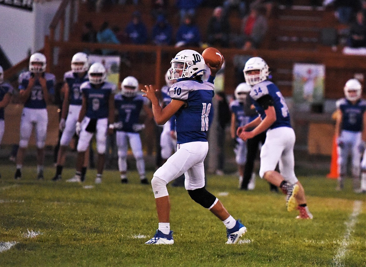 Mission quarterback Kellen McClure fires off a pass as teammate Lane Spidel swings out into the flat. (Scot Heisel/Lake County Leader)