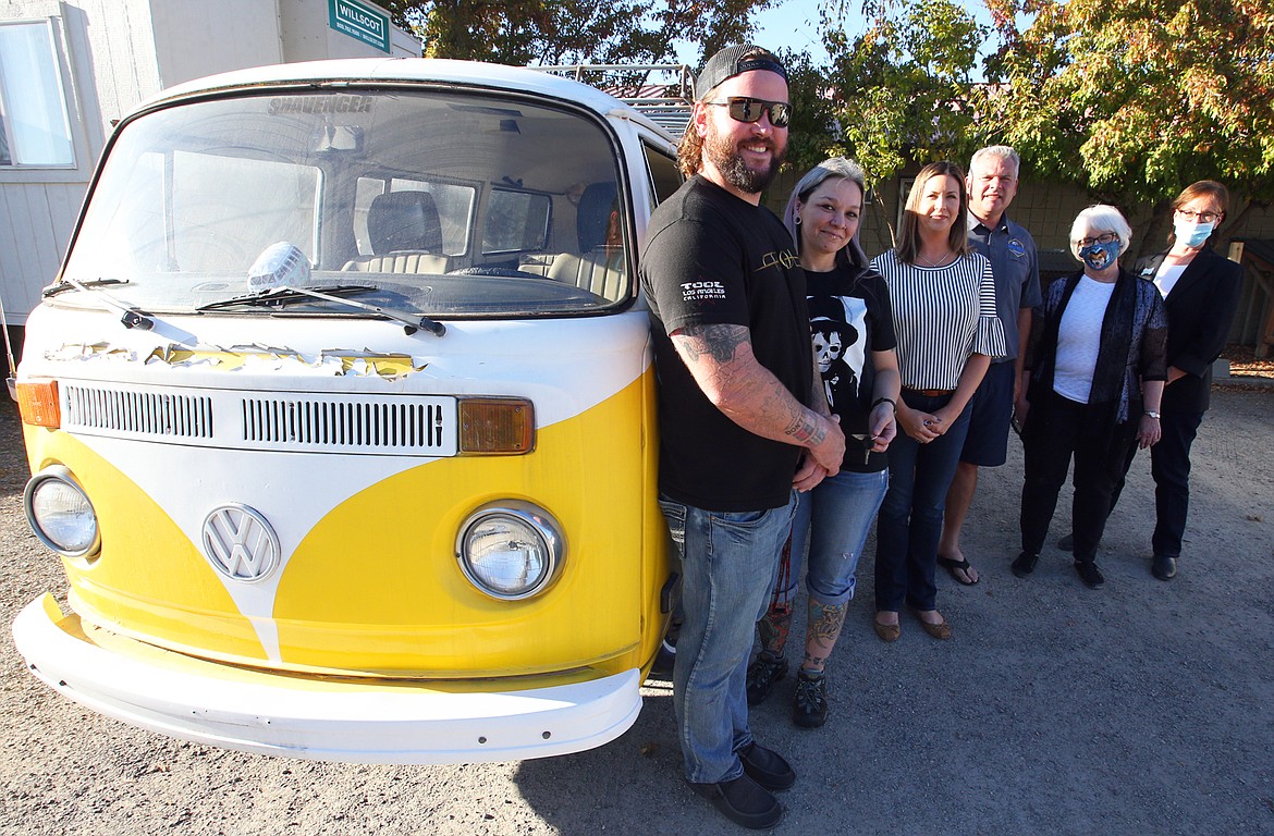 Brenda Busch, second from left, won the 1976 Volkswagen Bus in a drawing that benefits the Kootenai Humane Society. She is joined Tuesday, from left, by her partner AJ Sebek, Jessica Namson and Jonah Namson, owner of Post Falls Volkswagen, Debbie Jeffrey, KHS executive director and Vicky Nelson, KHS development director.