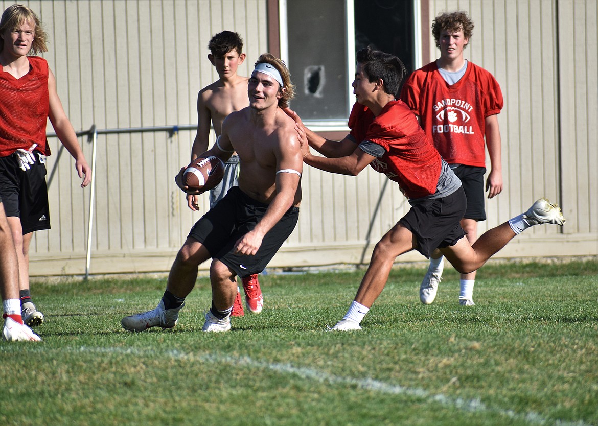 Gerrit Cox (left) gets "tackled" by a middle schooler on Wednesday.