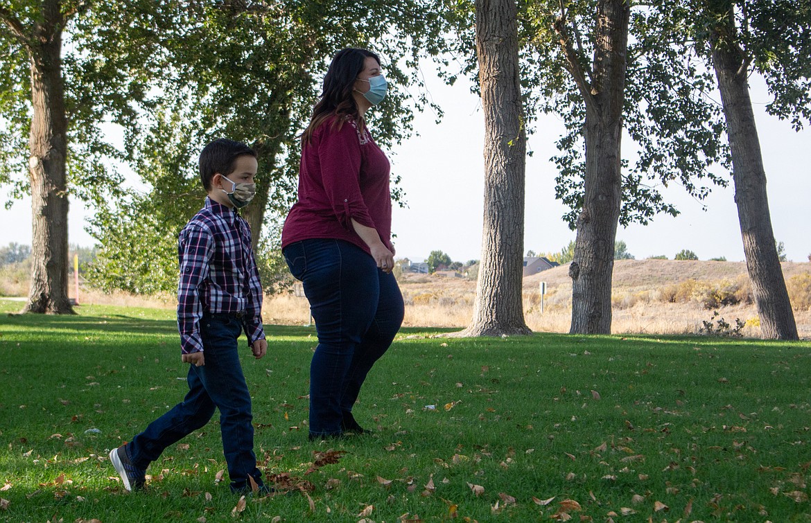 Hunter Krcma, left, and his aunt, Kristen Krcma, search around Blue Heron Park on Wednesday, Oct. 7, for the Moses Lake Parks & Recreation's Park Bingo Scavenger Hunt.