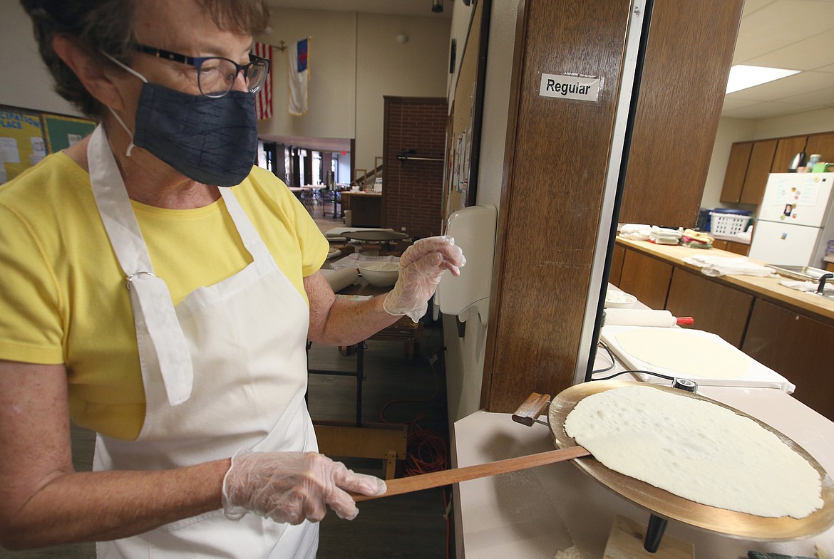 Winnie Barth monitors lefse on the griddle.