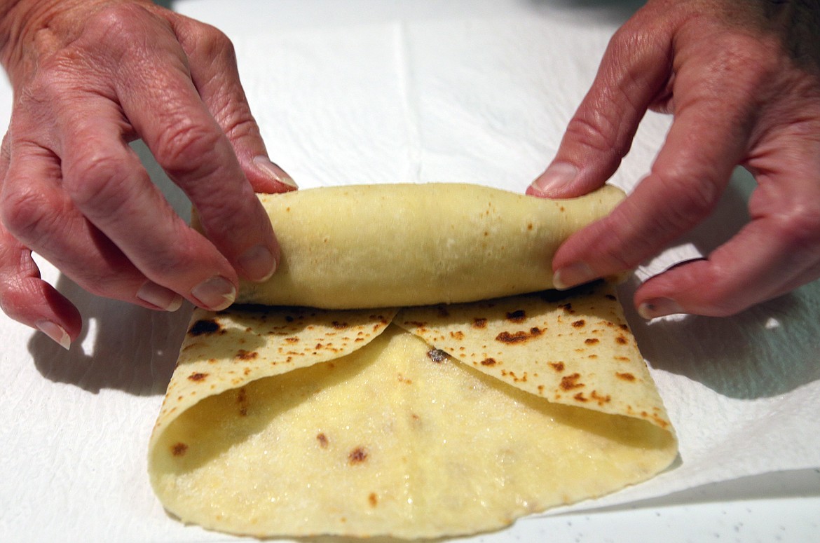 Dolores Johnson rolls up a round of lefse.