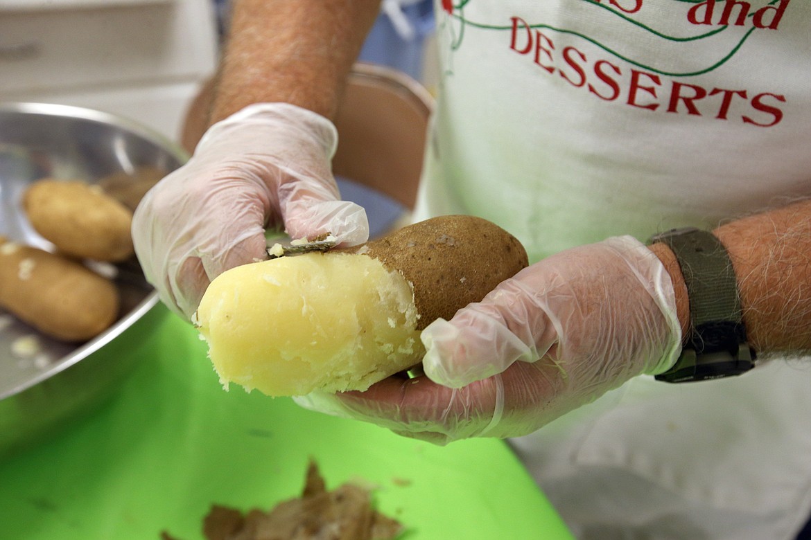 Tad Johnson peels a potato on Wednesday.