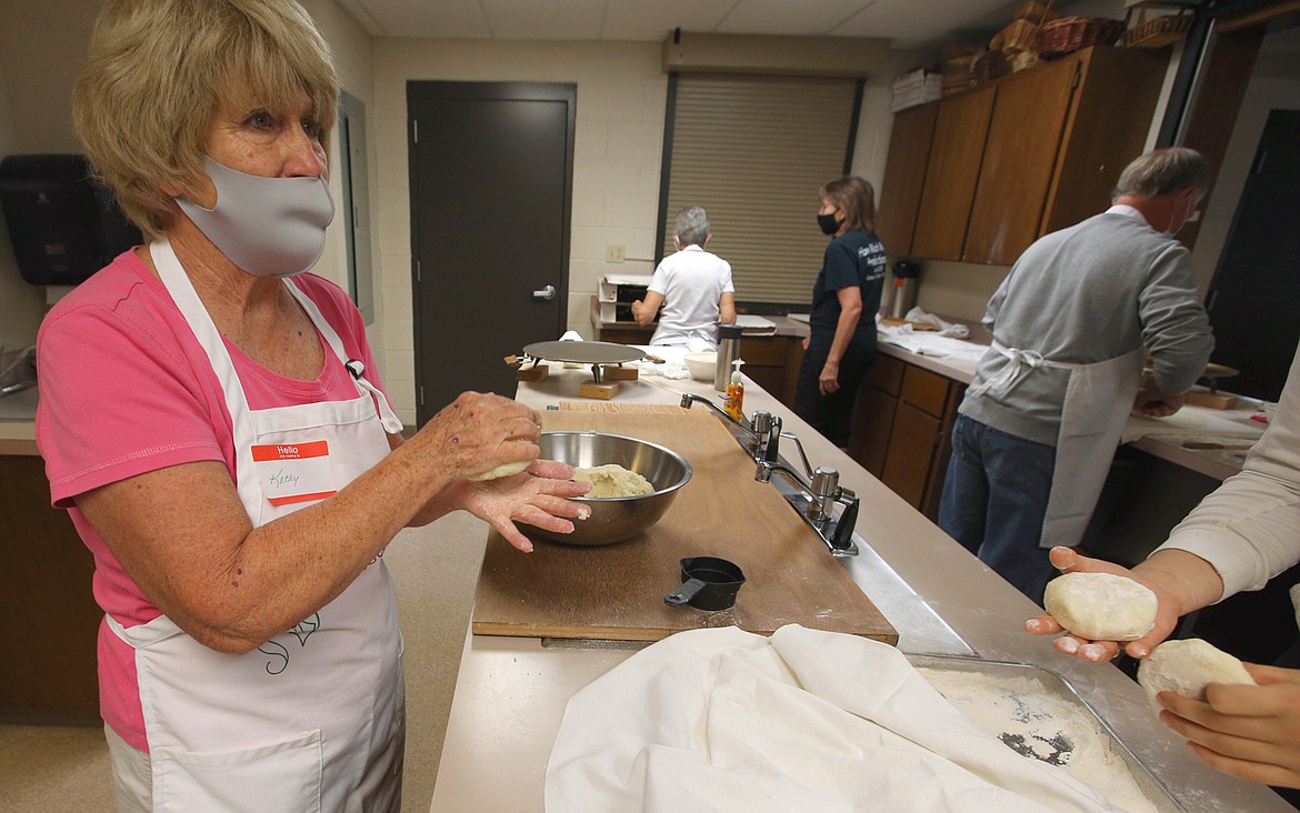 Kathy Benson turns dough into "hockey pucks" in the process of making lefse.