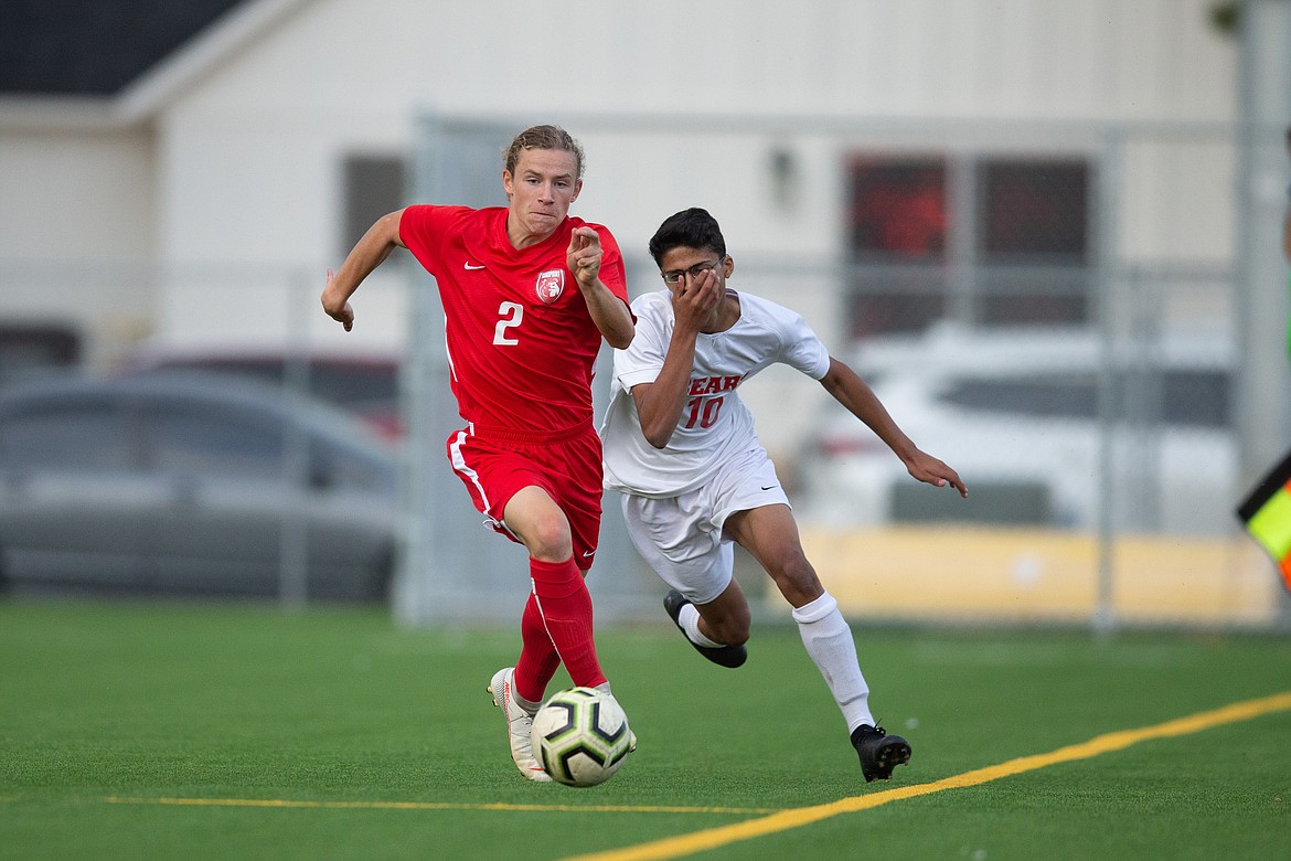 Freshman Jett Longanecker fights off a Moscow defender for possession of the ball during a game at War Memorial Field on Oct. 8.