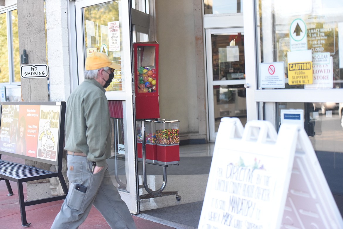 A masked man enters Rosauers in Libby on Oct. 7. Coronavirus cases continued to climb throughout the week.