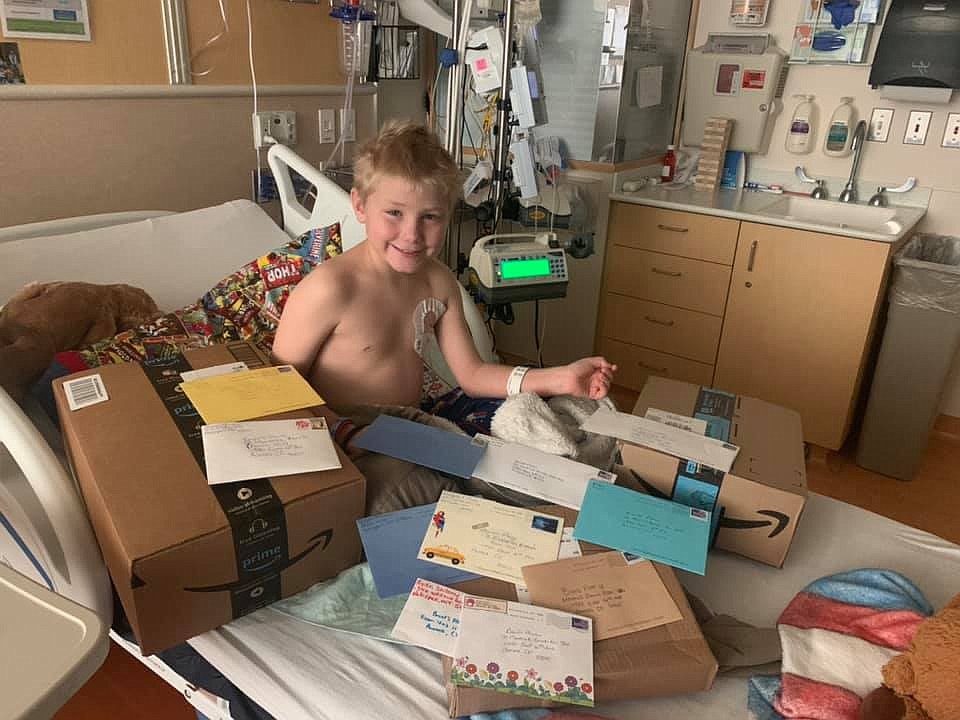 Maverick Bench looks over the numerous cards and packages he has received from "Maverick's Army" during his fight against aplastic anemia. (photo provided)