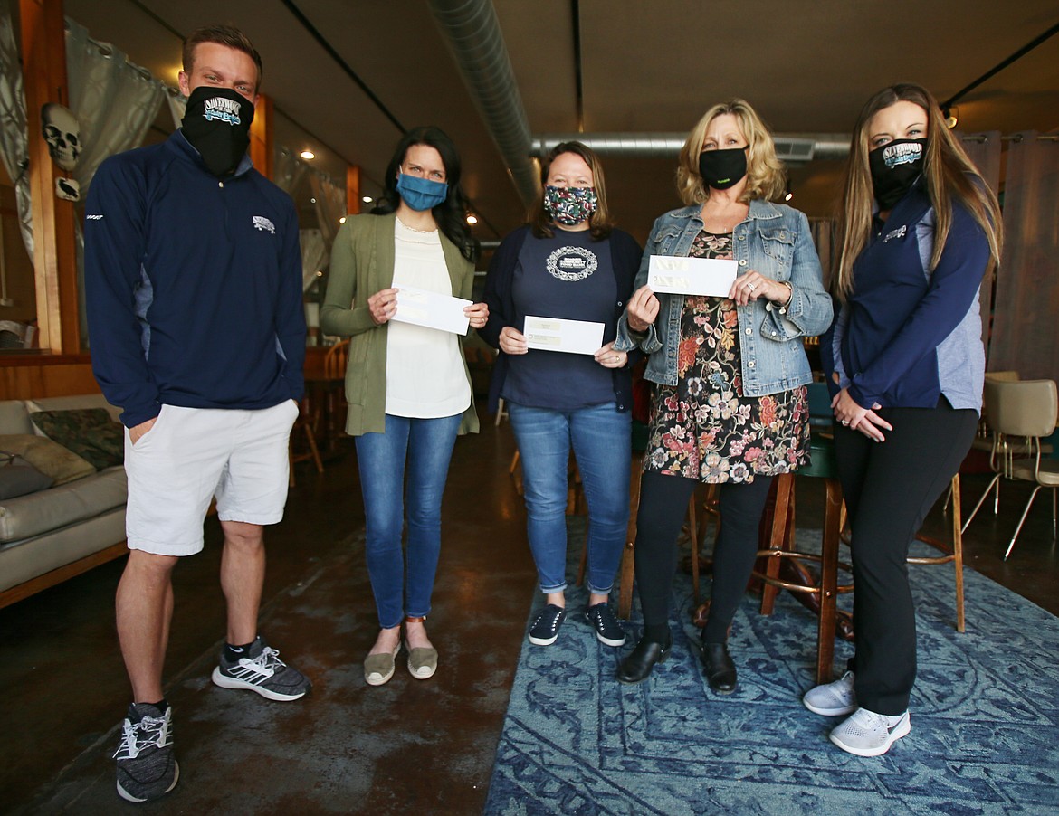 Silverwood Theme Park donated more than $31,400 to area food banks on Thursday. A funds distribution was held in Calypsos in downtown Coeur d'Alene. From left: Jordan Carter, Silverwood; Shannon Kinney, Second Harvest; Debbie Love, Bonner Community Food Bank; Leslie Orth, Post Falls Food Bank; and Stephanie Sampson, Silverwood.