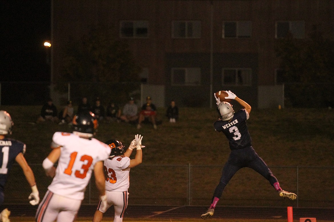 MARK NELKE/Press
Josiah Weaver (3) of Lake City intercepts a pass intended for Christian Curlee (83) of Post Falls in the first half Friday night at Lake City.