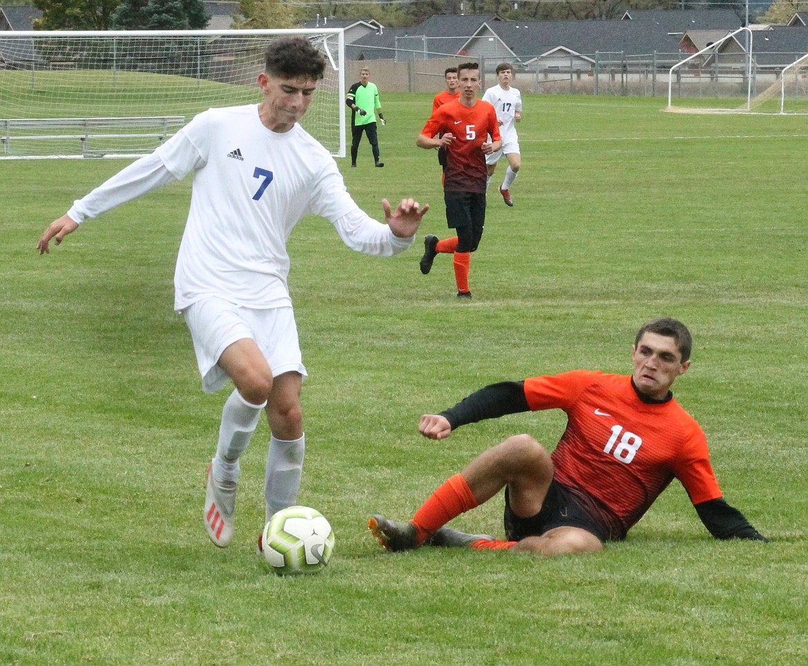 JASON ELLIOTT/Press
Coeur d'Alene junior midfielder Alex Reyes moves past the tackle of Post Falls defender Lars Horning during the first half of Saturday's 5A Region 1 boys soccer semifinal match at Post Falls High.