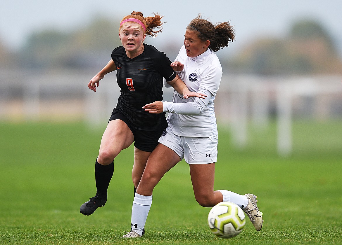 Flathead’s Skyleigh Thompson (9) gets past Butte’s Taylor Burke (2) in the first half at Kidsports Complex on Saturday. (Casey Kreider/Daily Inter Lake)