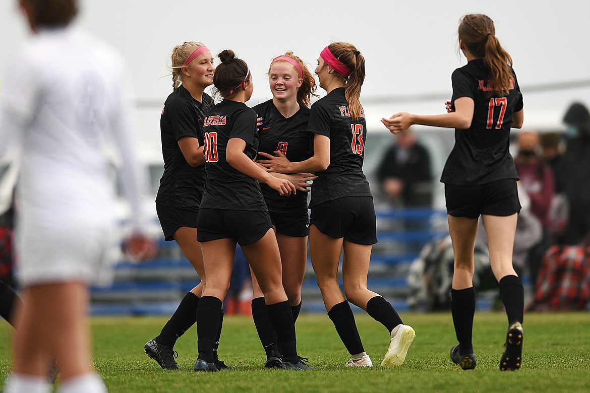 Flathead teammates, from left, Aleeya Derlatka (6), Ashlynn Whiteman (10), Skyleigh Thompson (9), Tessa Smith (13) and Grayce Siderius (17) celebrate after a goal by Thompson in the first half against Butte at Kidsports Complex on Saturday. (Casey Kreider/Daily Inter Lake)