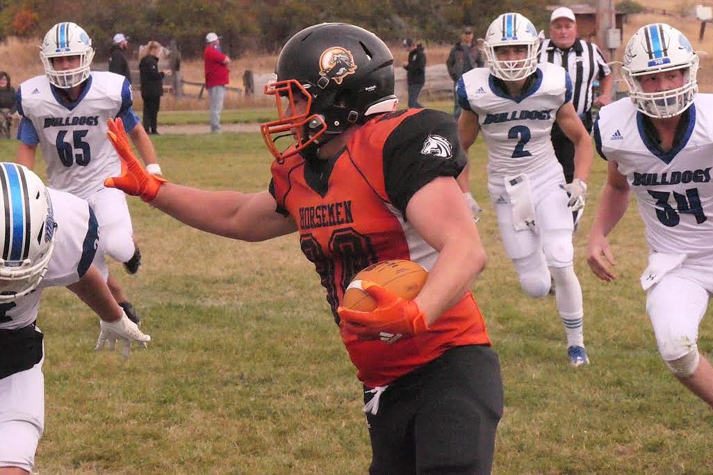 Plains running back Tucker Foster gets ready to stiff arm a Mission defender for yardage. (Chuck Bandel/Valley Press)