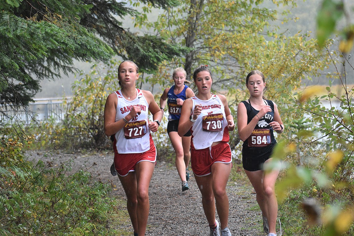 Sophomore Ara Clark (left) and junior Megan Oulman run side-by-side during Saturday's William Johnson Sandpoint Invitational.