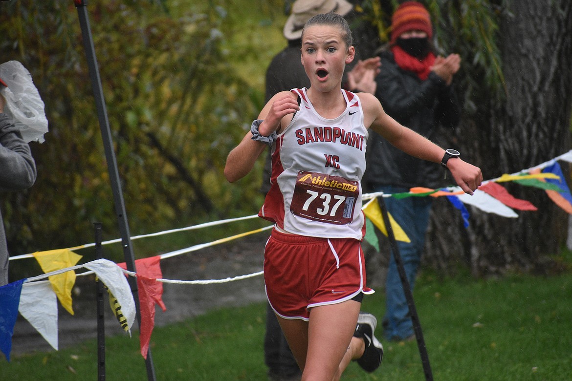 Tiffany Brown celebrates after crossing the finish line during Saturday's William Johnson Sandpoint Invitational.