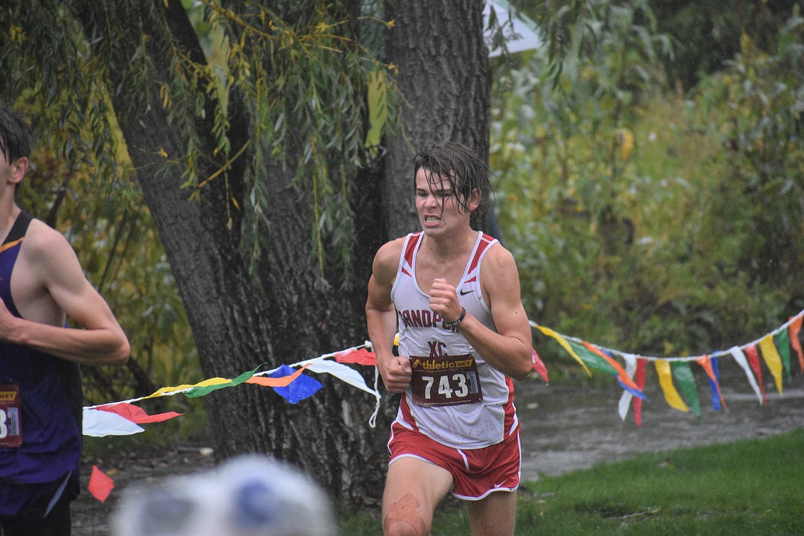 Junior Trey Clark digs deep as he nears the finish line of Saturday's William Johnson Sandpoint Invitational.