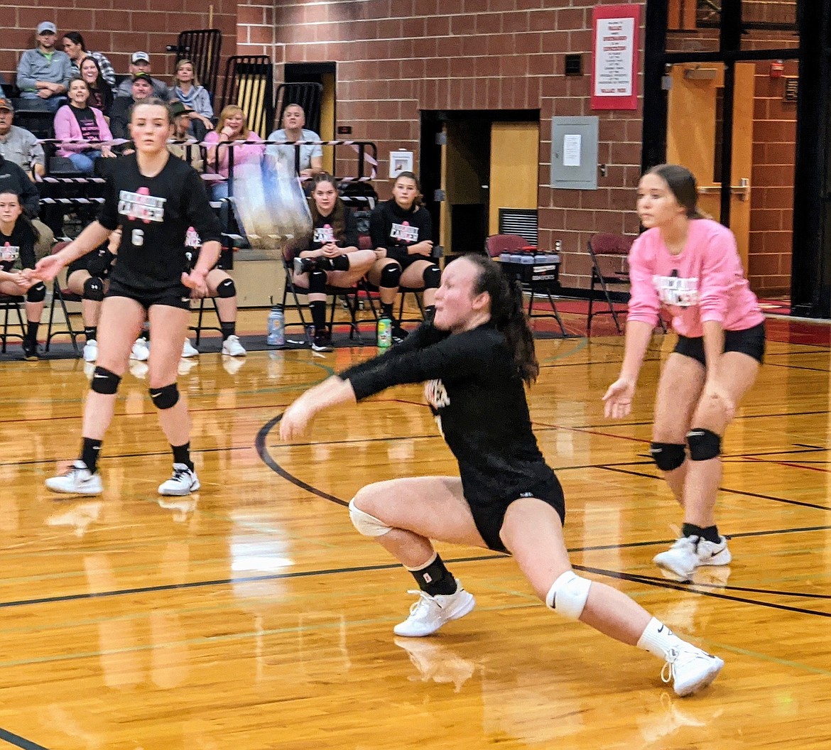 Miner Kendall Lohr Digs out a Wildcat hit during Dig Pink at WHS. The event is an annual cancer fundraiser between the Wallace and Kellogg volleyball teams.