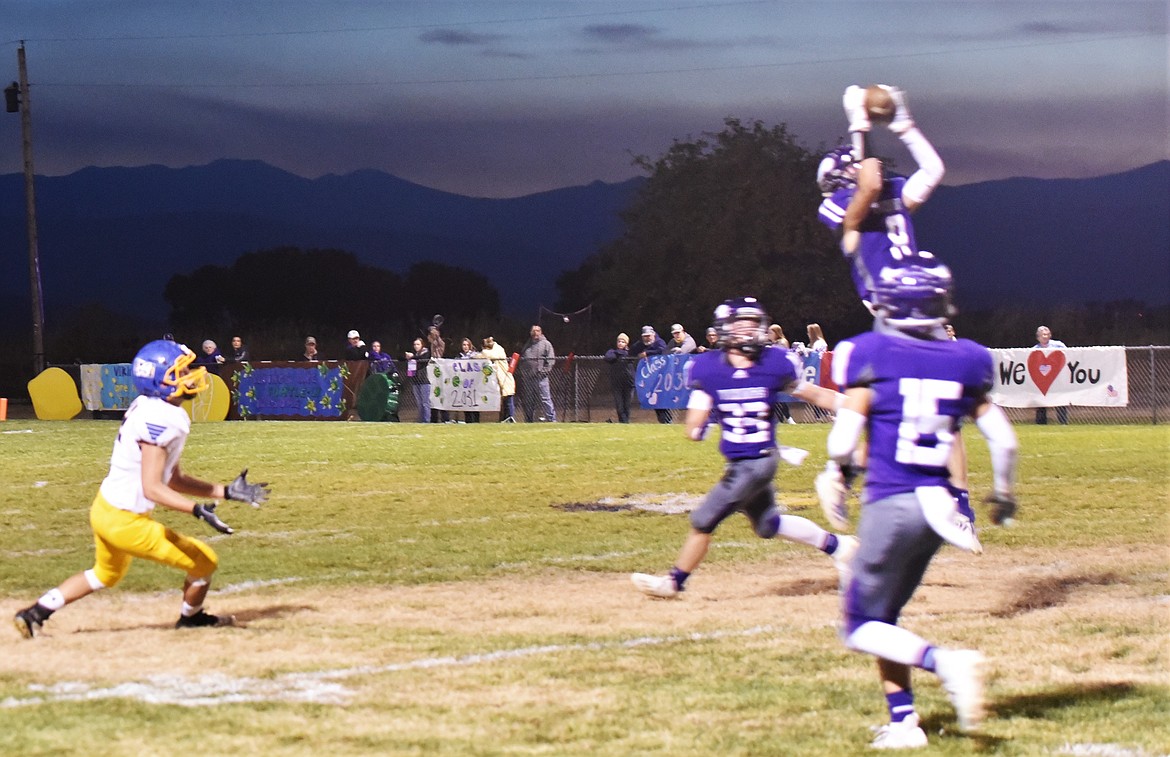 Braydon Zempel (8) rises for one of his two interceptions in front of teammates Tucker Love (33) and  Phil Marquez (15). (Scot Heisel/Lake County Leader)