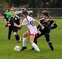 Photo by MARCEE HARTZELL
Thorns North FC girls 07 Red defender Ava Glahe steals a ball from a FC Spokane G06 Bliss player in Sunday's matchup. The Thorns defeated FC Spokane 2-1 in WISL play. Natalie Thompson scored both Thorns goals, one on a penalty kick and one unassisted.