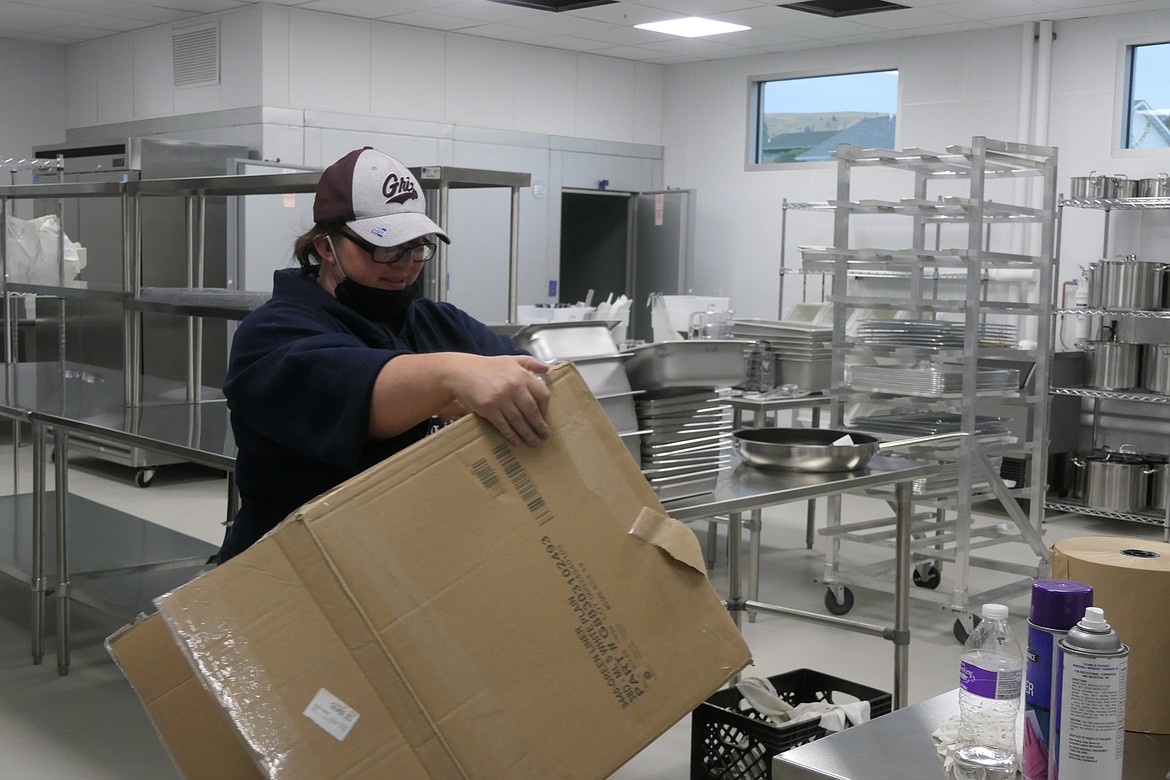 Amanda Baltz-Gainan helps unpack supplies and break down cardboard during the move-in. Amanda works the front desk at the Ronan Boys and Girls Club. (Carolyn Hidy/Lake County Leader)