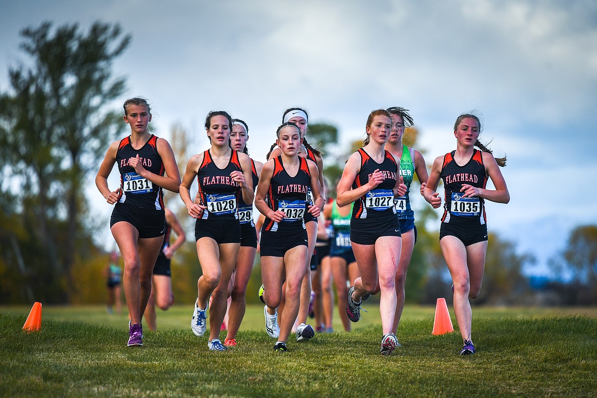 Flathead runners, from left, Hannah Perrin (1031), Neila Lyngholm (1028), Lilli Rumsey Eash (1032), Madelaine Jellison (1027) and Kya Wood (1035) keep the pace during the Glacier Invite at Rebecca Farm on Wednesday. (Casey Kreider/Daily Inter Lake)