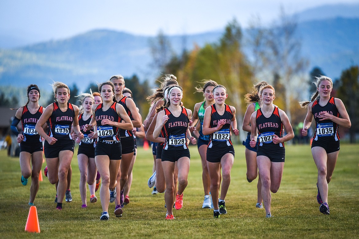 Flathead runners, from left, Neila Lyngholm (1028), Tori Noland Gillespie (1029), Lilli Rumsey Eash (1032), Madelaine Jellison (1027) and Kya Wood (1035) lead the pack at the start of the Glacier Invite at Rebecca Farm on Wednesday. (Casey Kreider/Daily Inter Lake)