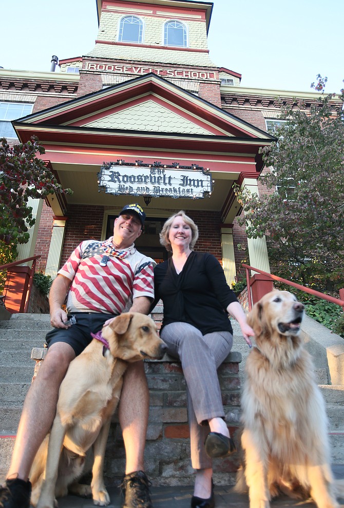 John and Tina Hough, in front of the Roosevelt Inn with pets Gondor and Rohan, are in the process of selling the historic bed and breakfast after 21 years. They're hoping the right buyer comes along within two years so they can retire and spend more time with the grandkids.