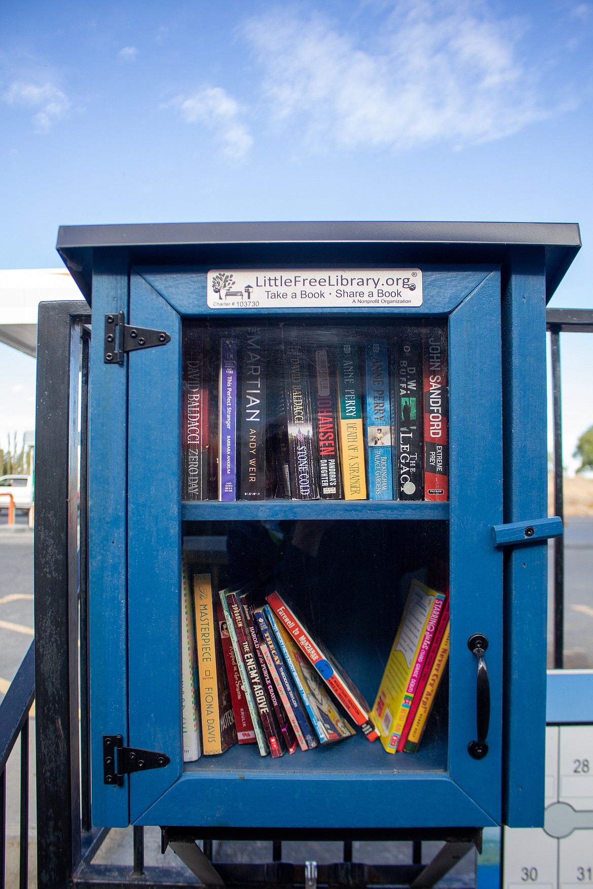 Books line the shelves of the Little Free Library located near Potholes General Store.
