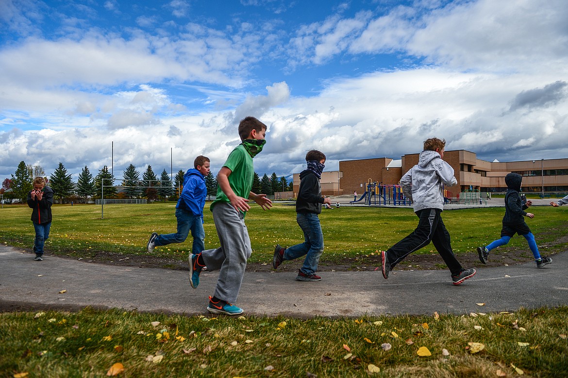Third-graders jog around a new walking path outside Edgerton Elementary School in Kalispell on Wednesday, Oct. 14. (Casey Kreider/Daily Inter Lake)