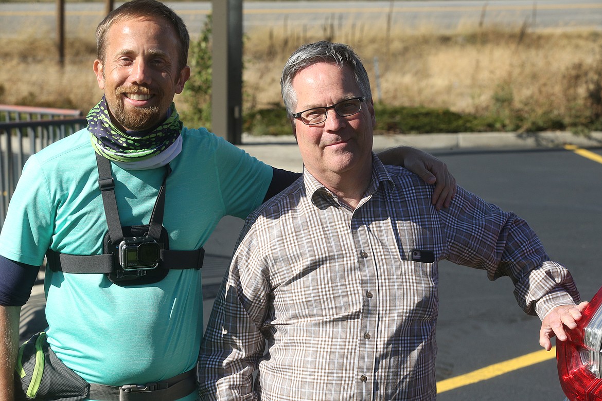 Ryan Worthen joins his father, Mark Worthen, on Thursday in Post Falls as they near the finish line of their journey that started Sept. 21 in Copalis Beach near Ocean Shores, Wash. and ended in Rathdrum.