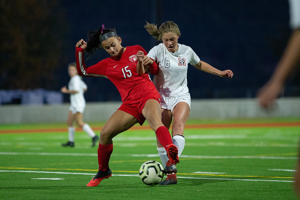 Senior Jordie Breeden fights a Moscow player for possession of the ball during the 4A Region 1 final on Oct. 15 at War Memorial Field.