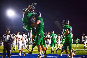 Glacier tight end Luke Bilau (4), left, celebrates with running back Jake Rendina (33) after Rendina's 34-yard touchdown reception in the second quarter against Flathead in crosstown football at Legends Stadium on Friday. (Casey Kreider/Daily Inter Lake)
