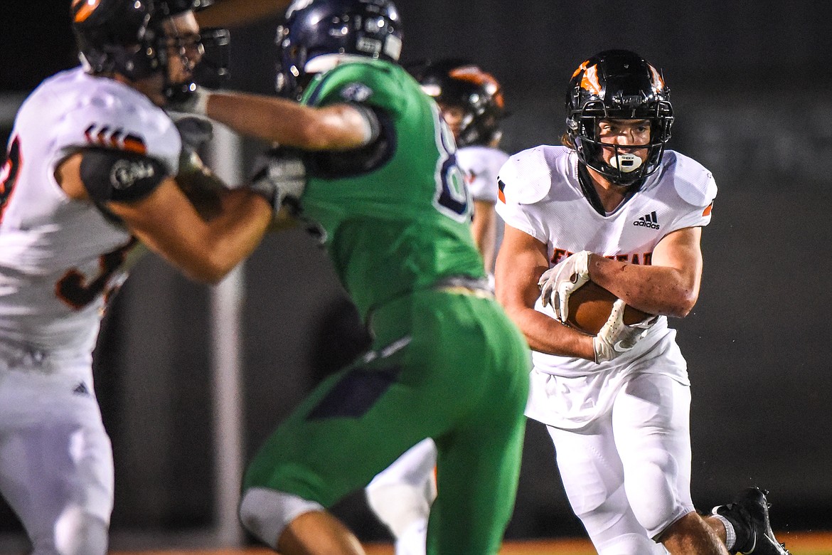 Flathead running back Alec Thomas (14) looks for room to run against the Glacier defense in the first half during crosstown football at Legends Stadium on Friday. (Casey Kreider/Daily Inter Lake)