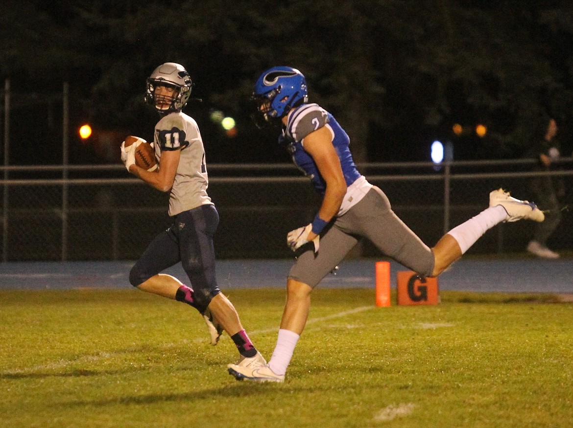 MARK NELKE/Press
Damon Rosenau of Lake City looks back as he races to the end zone on a 25-yard pass reception against Coeur d'Alene on Friday night at Viking Field.