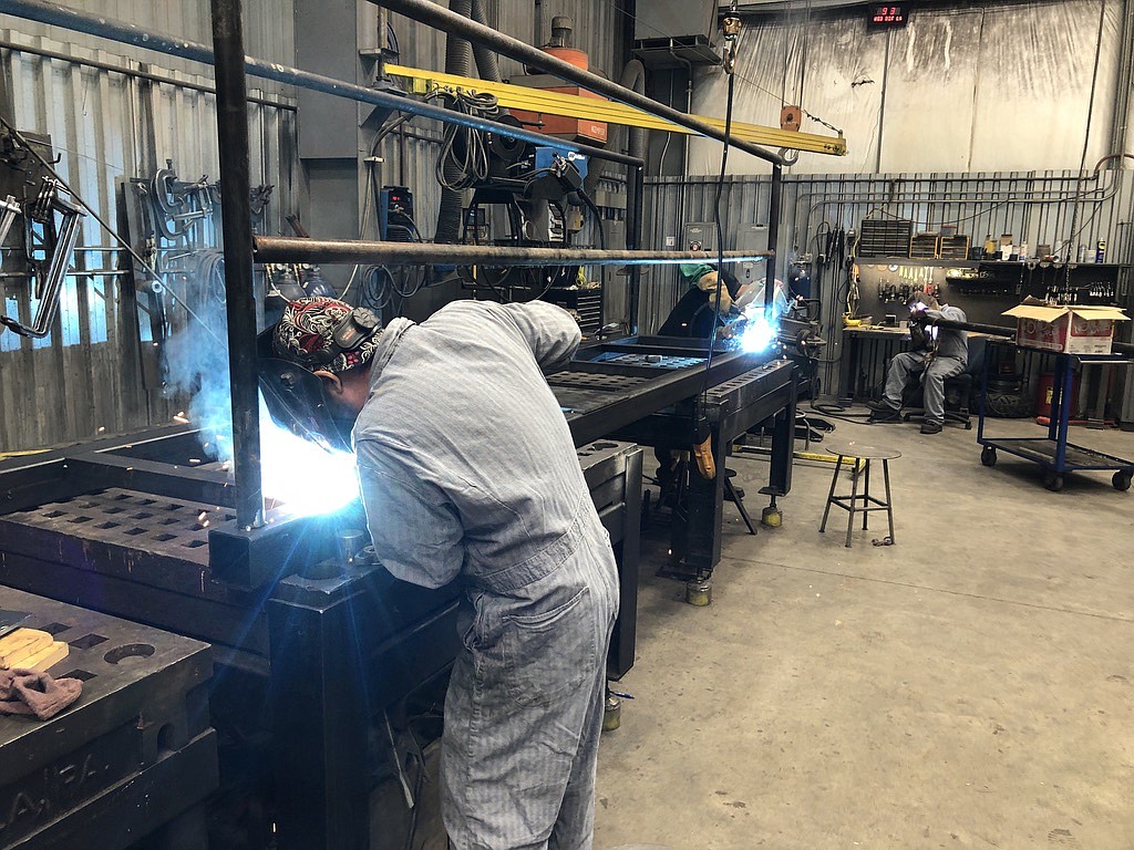 Workers at Pasco Machine weld a catwalk.