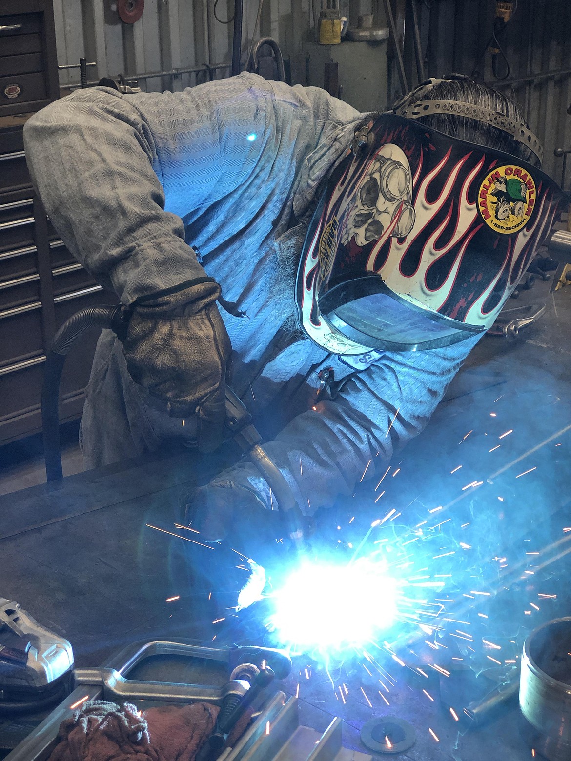 Steve Escoabr, a machinist at Pasco Machine, welds together a special roller designed to clear off conveyor belts.