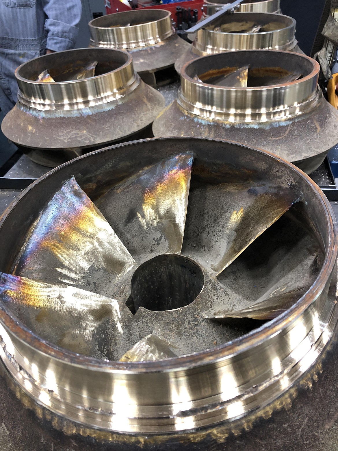 Refurbished bronze impeller blades for large pumps used in irrigation.