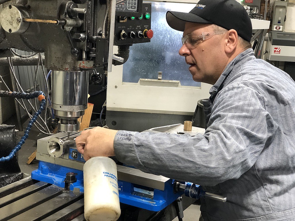 Pasco Machine machinist Gary Flansburg mills a spout designed to fill wine bottles. Flansburg, a 19-year veteran of Pasco Machine, said he was making 100 of them.