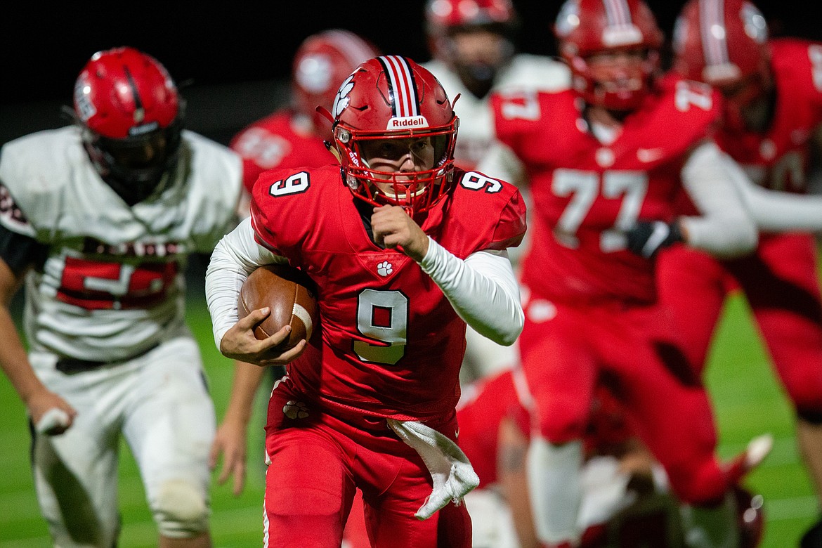 Sophomore quarterback Parker Pettit runs through the Moscow defense during Friday's game at War Memorial Field.
